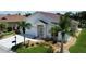 White house with red tile roof, landscaping, and a driveway at 24327 Buckingham Way, Punta Gorda, FL 33980