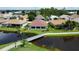 Back of house with a canal view and walkway at 24327 Buckingham Way, Punta Gorda, FL 33980