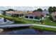 Back of house overlooking a canal and walkway at 24327 Buckingham Way, Punta Gorda, FL 33980