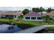 Back of house with pool and view of canal at 24327 Buckingham Way, Punta Gorda, FL 33980