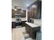 Modern kitchen with dark wood cabinets and quartz countertops at 24327 Buckingham Way, Punta Gorda, FL 33980