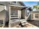 Back porch with gray siding, white door and steps at 907 E North Bay St, Tampa, FL 33603