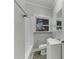 Updated bathroom with white vanity, tub, and gray walls at 907 E North Bay St, Tampa, FL 33603