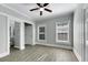 Bedroom with ceiling fan, grey walls, wood-look flooring and en-suite bathroom at 907 E North Bay St, Tampa, FL 33603