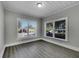 Bedroom with two windows, wood-look flooring, and grey walls at 907 E North Bay St, Tampa, FL 33603
