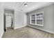 Bright bedroom with grey walls, wood-look flooring, and two closets at 907 E North Bay St, Tampa, FL 33603