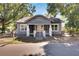 Charming bungalow exterior, gray siding, white trim, and a welcoming front porch at 907 E North Bay St, Tampa, FL 33603