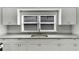 Renovated kitchen features white cabinets, granite countertops, and stainless steel sink at 907 E North Bay St, Tampa, FL 33603
