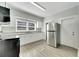 Modern kitchen with white cabinets, granite counters, and stainless steel appliances at 907 E North Bay St, Tampa, FL 33603