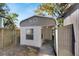 Detached workshop with gray shingle roof and white painted walls at 907 E North Bay St, Tampa, FL 33603