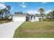 Newly built home with gray exterior, white garage door, and spacious lawn at 13459 Keystone Blvd, Port Charlotte, FL 33981