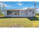 Modern house exterior with covered patio and landscaped yard at 14480 Argus Ln, Port Charlotte, FL 33981