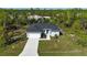 Single-story house aerial view, showcasing the home's design and landscaping at 15076 Ingraham Blvd, Port Charlotte, FL 33981