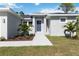 Modern front entrance with blue door and landscaping at 15076 Ingraham Blvd, Port Charlotte, FL 33981