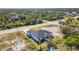 Scenic aerial shot of a single-Gathering home showcasing its well-maintained exterior and large yard at 14346 San Domingo Blvd, Port Charlotte, FL 33981