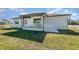 A bright, sunny view of the home's backyard and covered back porch at 14346 San Domingo Blvd, Port Charlotte, FL 33981
