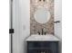 Charming powder room with a marble countertop, designer mirror, and unique tile backsplash at 14346 San Domingo Blvd, Port Charlotte, FL 33981