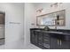 Bathroom features a double sink vanity with black granite countertop and modern lighting at 14346 San Domingo Blvd, Port Charlotte, FL 33981