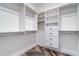 Walk-in closet featuring built-in shelves, drawers, and hardwood floors at 14346 San Domingo Blvd, Port Charlotte, FL 33981