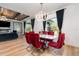 Elegant dining room with modern chandelier, dark wood accents, and red velvet chairs at 14346 San Domingo Blvd, Port Charlotte, FL 33981