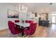 Elegant dining area with modern chandelier, marble table, and views into the stunning kitchen at 14346 San Domingo Blvd, Port Charlotte, FL 33981