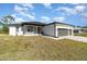 Beautiful shot of the home's exterior with a large three-car garage and well-kept lawn at 14346 San Domingo Blvd, Port Charlotte, FL 33981