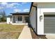Detailed front exterior showing stone facade, three car garage, and inviting walkway to entrance at 14346 San Domingo Blvd, Port Charlotte, FL 33981