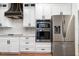 Contemporary kitchen featuring stainless steel appliances, custom cabinets, and wood-look flooring at 14346 San Domingo Blvd, Port Charlotte, FL 33981