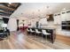 Modern, open-concept kitchen with black countertops, white cabinets, stainless appliances, and dining area at 14346 San Domingo Blvd, Port Charlotte, FL 33981