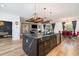Spacious kitchen features a black island with marble countertop, stainless steel appliances, and wood floors at 14346 San Domingo Blvd, Port Charlotte, FL 33981