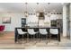 Elegant kitchen island with pendant lighting, breakfast bar seating, and stylish white cabinetry at 14346 San Domingo Blvd, Port Charlotte, FL 33981