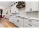 Modern kitchen features white cabinets, black hardware, stainless steel appliances, and a stylish backsplash at 14346 San Domingo Blvd, Port Charlotte, FL 33981