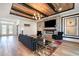 Bright living room features a stone fireplace, modern lighting, and hardwood floors at 14346 San Domingo Blvd, Port Charlotte, FL 33981