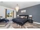 Main bedroom features a luxurious chandelier, a large window, and hardwood floors at 14346 San Domingo Blvd, Port Charlotte, FL 33981