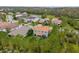 Aerial view of the house, showcasing proximity to a pond, greenery and the community at 32924 Estate Garden Dr, Wesley Chapel, FL 33545