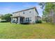 Spacious backyard with patio area, trampoline and lush green lawn at 32924 Estate Garden Dr, Wesley Chapel, FL 33545