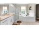 Bright bathroom with a glass-enclosed shower, a soaking tub, and updated fixtures at 32924 Estate Garden Dr, Wesley Chapel, FL 33545