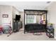 Large bedroom featuring a black canopy bed frame, dresser, and carpeted floors at 32924 Estate Garden Dr, Wesley Chapel, FL 33545