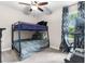 Bedroom with a bunk bed, work station, and carpeted floors at 32924 Estate Garden Dr, Wesley Chapel, FL 33545