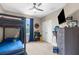 Bedroom with a bunk bed, dark blue accents, and a view to the outside at 32924 Estate Garden Dr, Wesley Chapel, FL 33545