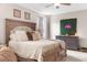 Relaxing bedroom with a large bed, modern decor, and a vibrant wall that adds character to the room at 32924 Estate Garden Dr, Wesley Chapel, FL 33545