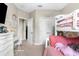 Bright bedroom with a bunk bed, desk, and carpeted floors at 32924 Estate Garden Dr, Wesley Chapel, FL 33545