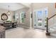 Open-concept room featuring a formal dining area with luxury wood-like tile at 32924 Estate Garden Dr, Wesley Chapel, FL 33545