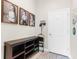 Mud room features decoratively framed Gathering photos and hooks to hang coats at 32924 Estate Garden Dr, Wesley Chapel, FL 33545