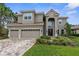 Beautiful home with a three-car garage, tile roof, and landscaped front yard at 32924 Estate Garden Dr, Wesley Chapel, FL 33545