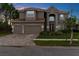 Stately two-story home featuring a three-car garage, red tile roof, and well-manicured landscaping at 32924 Estate Garden Dr, Wesley Chapel, FL 33545