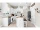Well-lit kitchen featuring white cabinets, stainless steel appliances, and a center island at 32924 Estate Garden Dr, Wesley Chapel, FL 33545