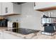 Close-up of a well-appointed counter with quartz countertops and tiled backsplash at 32924 Estate Garden Dr, Wesley Chapel, FL 33545