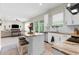 Modern kitchen with granite countertops, white cabinetry, and open floor plan at 32924 Estate Garden Dr, Wesley Chapel, FL 33545