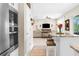 Open-concept living room with a view of the living space, kitchen island with marble countertops, and stainless-steel appliances at 32924 Estate Garden Dr, Wesley Chapel, FL 33545